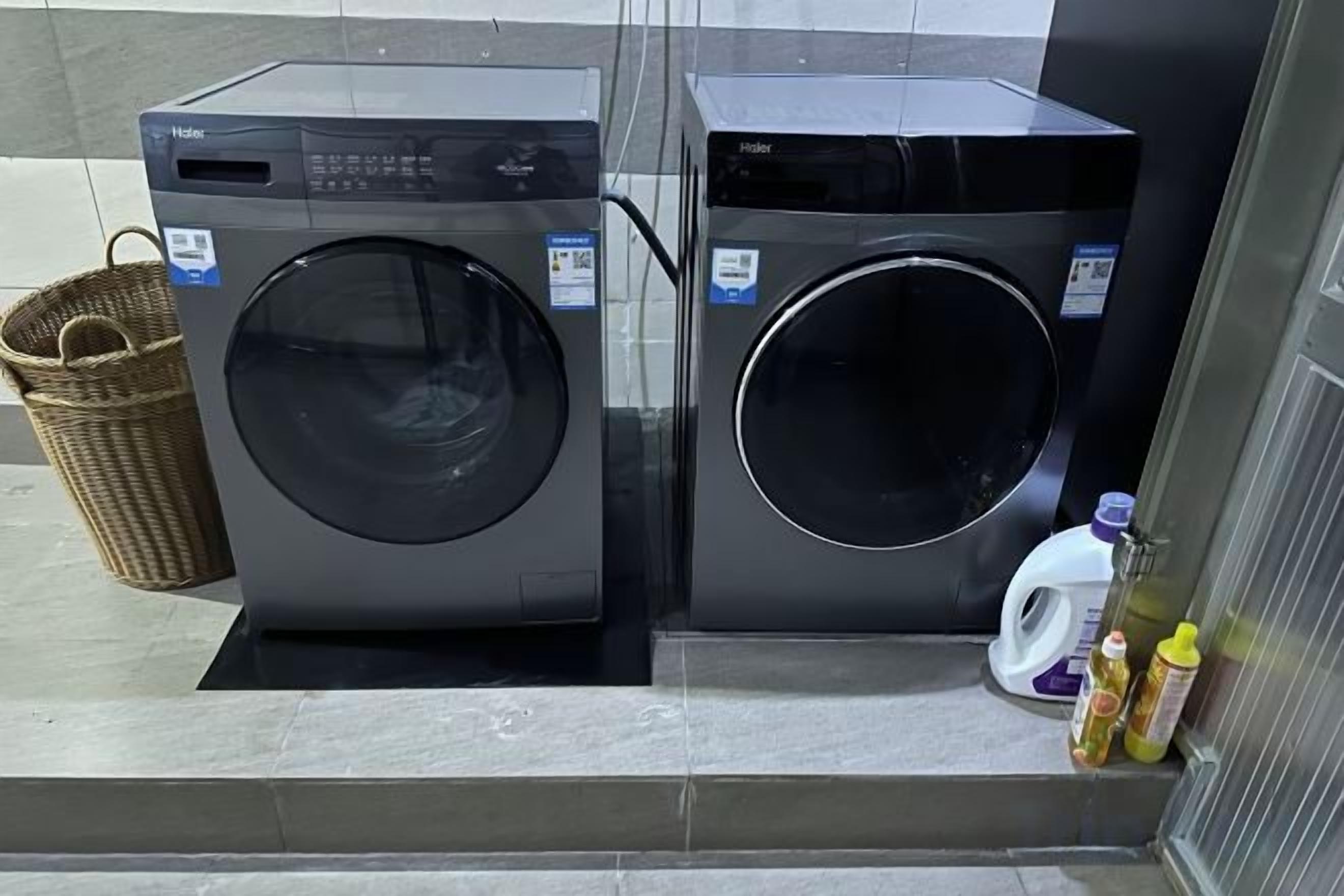Two front-loading washing machines in a commercial setting.