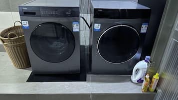 Two front-loading washing machines in a commercial setting.