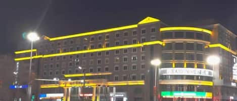 A multi-story hotel with a prominent entrance and a curved facade.