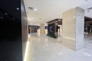 A modern interior with a polished floor, a reception area, and a glass partition.