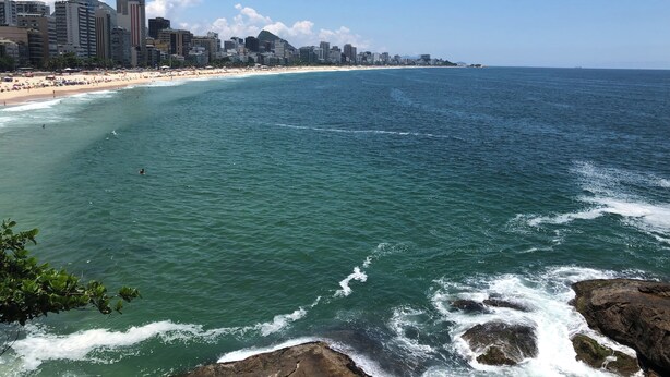 A coastal cityscape with a beach and ocean.