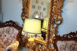A room with ornate furniture, a mirror, and a lamp. - Chateau De France Bed & Breakfast (Yilan)