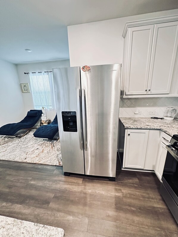 Enjoy cooking in this fully equipped kitchen with a refrigerator, coffee maker, and kettle.
