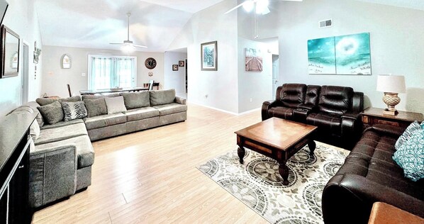 A living room with a sofa, a coffee table, and a fireplace.