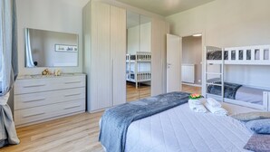 A bedroom with a bed, a wardrobe, a mirror, and a ceiling fan. - Sea Garden - T6 with parking, Ceriale, Italy (Ceriale)