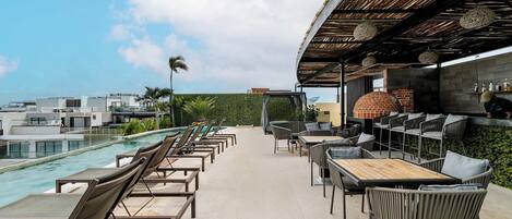 Sip your drink and soak up the sun on this lively rooftop.