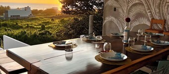 Warm room with the sea in the background and starry skies.