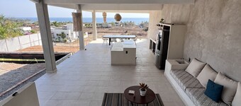 Warm room with the sea in the background and starry skies.
