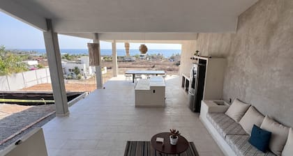 Warm room with the sea in the background and starry skies.
