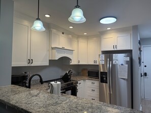 Fridge, microwave, oven, stovetop - Beach House at Garden City. 2-BR condo with private pool, on the beach. (Murrells Inlet)