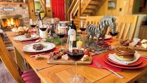 A wooden dining table set with plates, glasses, and a decorative zebra statue. - FALL HIDEOUT 3BR RETREAT•BIG DECK,GAME RM, FIREPIT,FIREPLACE•6BIKES•GOLF•FARMS (Lake Ariel)