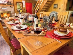 A wooden dining table set with plates, glasses, and a decorative zebra statue. - FALL HIDEOUT 3BR RETREAT•BIG DECK,GAME RM, FIREPIT,FIREPLACE•6BIKES•GOLF•FARMS (Lake Ariel)