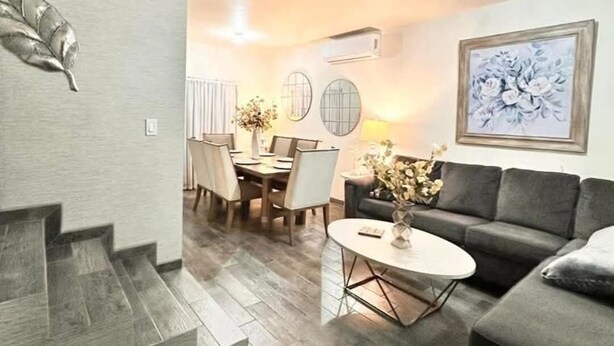 A modern living room with a staircase, a dining area, and a sofa. - Beautiful house in col independencia (Mexicali)
