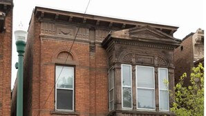 A two-story brick building with a black front door and a mailbox. - `The Hideaway` Modern Apartment w/Sauna and Grill (Troy)