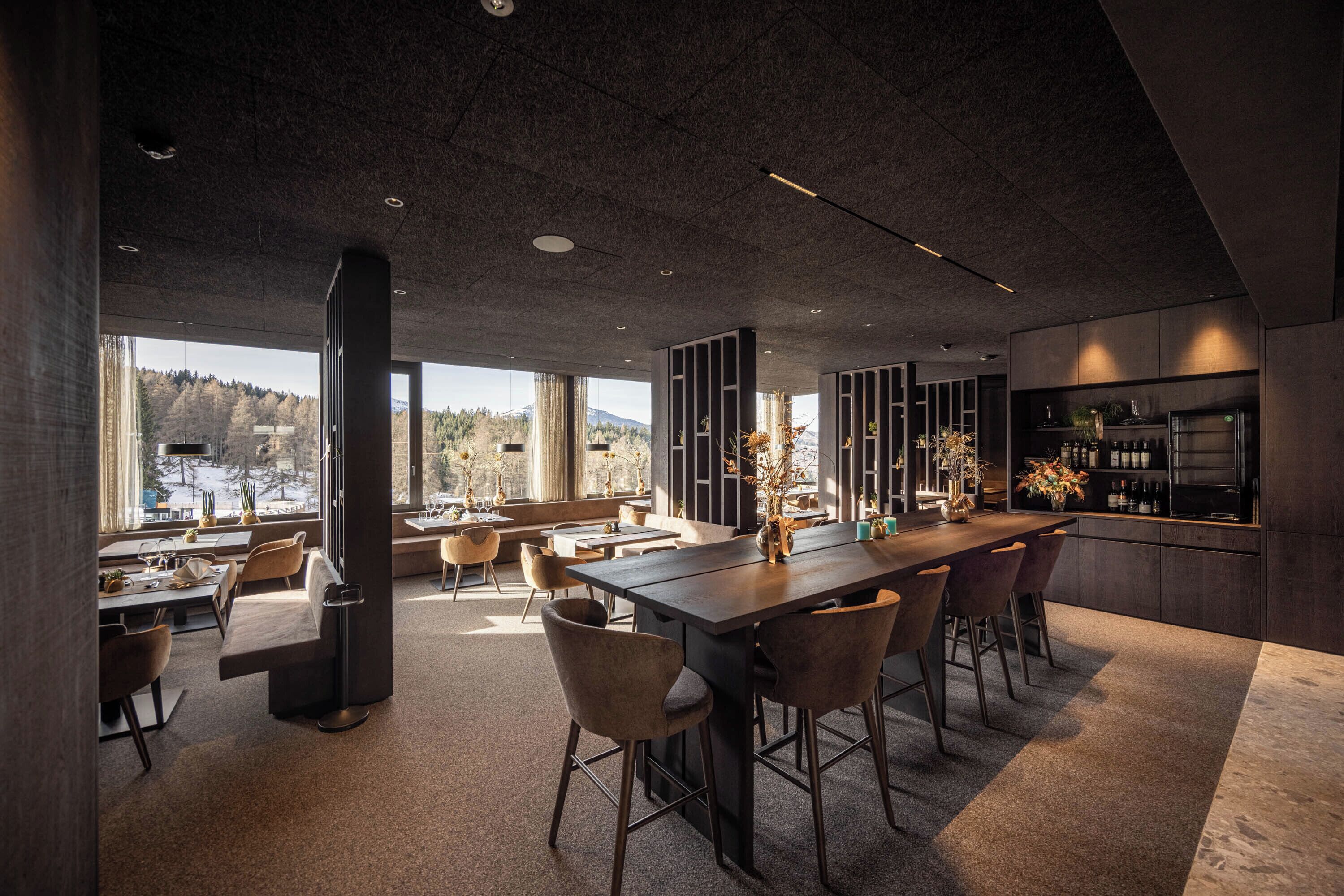 A modern kitchen with a large island, bar area, and seating.