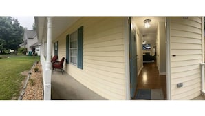 A house with a covered porch, a visible door, and a small garden area. - The Good Life Place in Smyrna (Smyrna)
