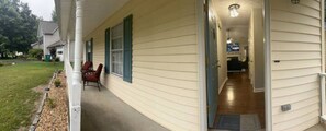 A house with a covered porch, a visible door, and a small garden area. - The Good Life Place in Smyrna (Smyrna)