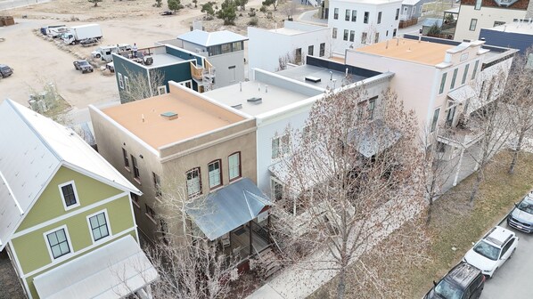 A residential area with multiple two-story houses, each featuring a flat roof and a front porch.