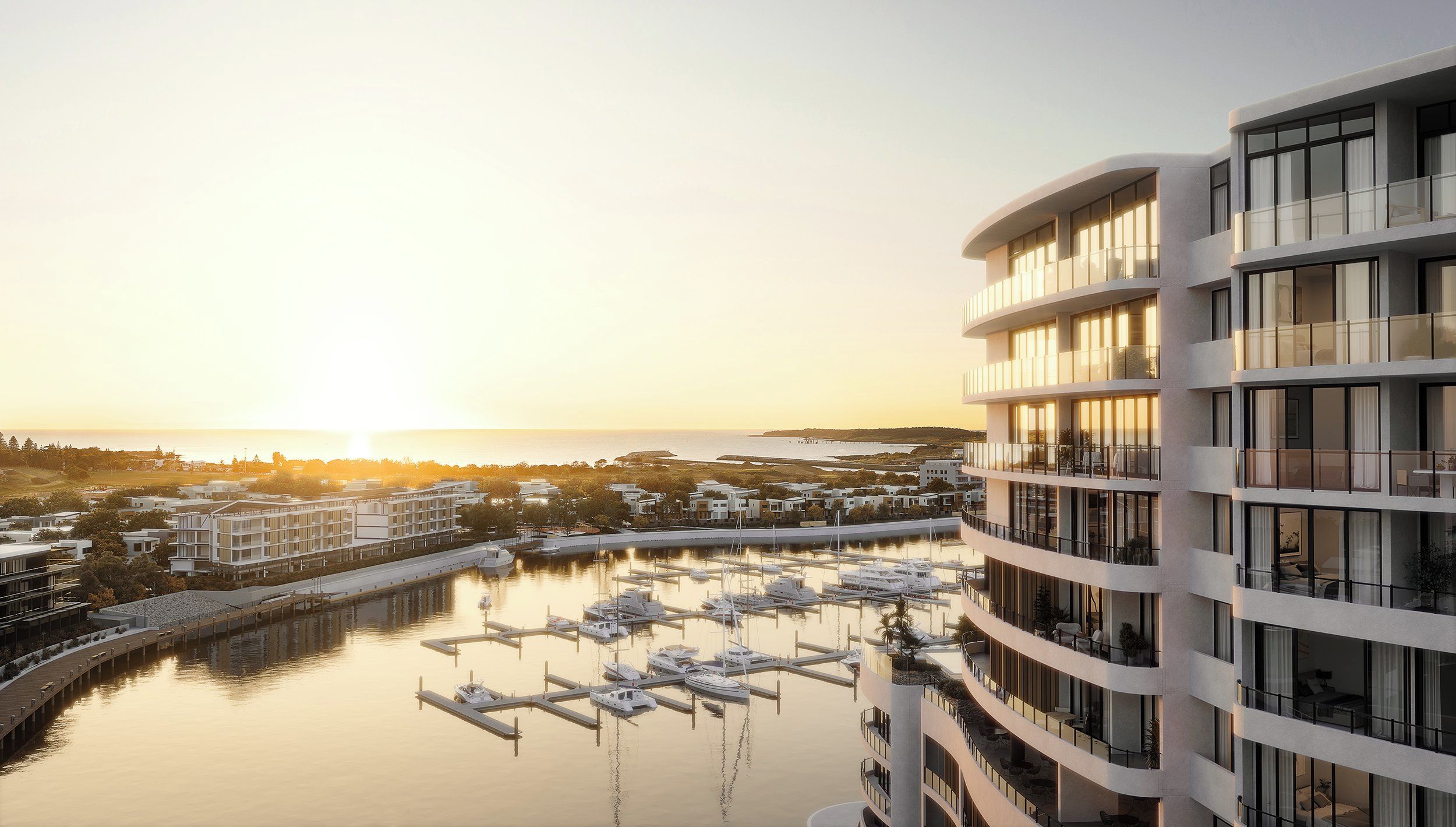 Un hotel moderno con varios balcones que dan a un puerto deportivo con barcos.