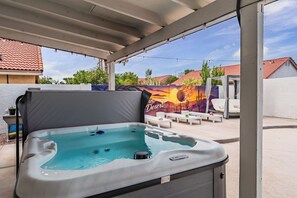A hot tub under a covered patio with a mural in the background. - Mesa Luxury Home. Hot tub, Pool, Golf, Basketball Court and MORE (Mesa)