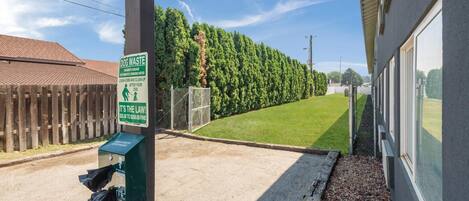 A dog waste station with a sign indicating a fine for non-compliance.