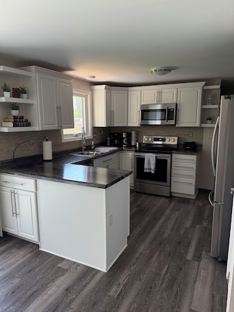 Fridge, microwave, oven, stovetop. Charming 3 Bedroom 2.5 bathroom finished basement, Huge yard and Charcoal grill