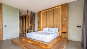 A modern bedroom with a large bed, wooden headboard, and ambient lighting. - Titi House Villa By Betterplace (Ubud)
