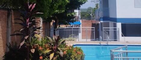 Outdoor pool, open 8:00 AM to midnight, pool umbrellas