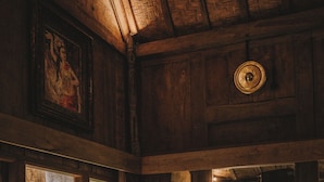 A wooden room with large windows, a wooden door, and a small table with a plant. - Umakayu Joglo Villa Bali Boutique Hotel (Canggu)
