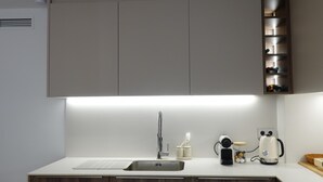 A modern kitchen with a built-in sink, wooden cabinets, and a stainless steel range hood.