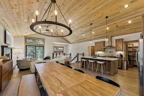 A spacious kitchen with a large island, wooden ceiling, and modern lighting fixtures. - The Pine & Trail Tahoe | 4BR | Hot Tub + 3 Kings (South Lake Tahoe)