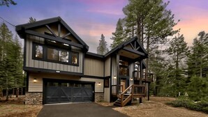 A modern two-story house with a garage, a staircase, and a deck. - Tahoe Forest Lodge: A/C, Hot Tub, Pool Table (South Lake Tahoe)