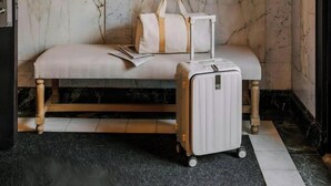 A room with a bench, a suitcase, and a decorative light fixture. - No. 284 Powered by Sonder (Boston)