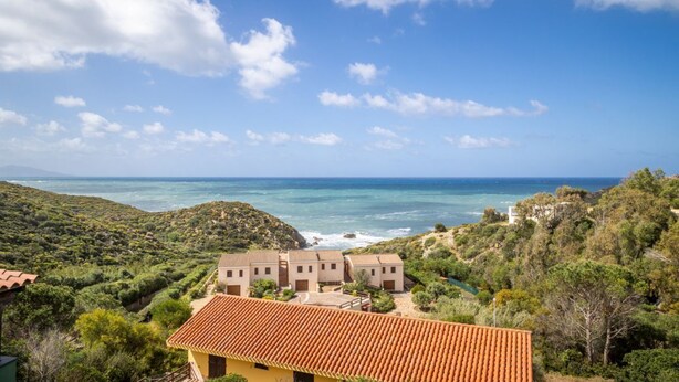A coastal property with terracotta-roofed buildings, a view of the sea, and surrounding greenery. - GuestHost - Sea's Peace (Torre dei Corsari)