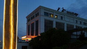 A large, illuminated column in an open plaza with a modern building in the background. - Rabat Resort Hotel (Adiyaman)
