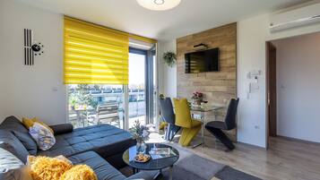 Family Apartment, 2 Bedrooms, Balcony, Lakeside (Sunset Resort 409 With Pool) | Living area | 21-inch Smart TV with cable channels