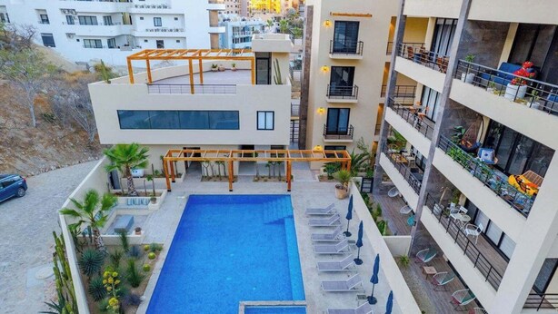 A rooftop pool with sun loungers and a pergola, surrounded by a landscaped garden. - 2BD, 2BA Luxury Penthouse with Private Rooftop in Cabo.  LOTS OF BEACH GEARS! (Cabo San Lucas)