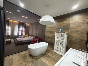 A modern bathroom with a freestanding bathtub, a white vanity, and a large mirror. - Casa Blu (Tbilisi)