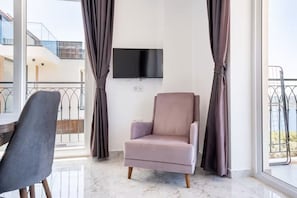 Departamento básico, balcón, vista al mar | Área de sala de estar | Televisión LED de 32 pulgadas con canales por cable
