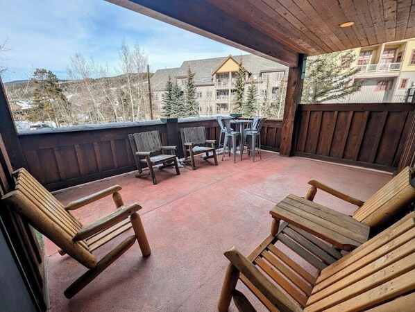 A wooden deck with outdoor seating and a view of a residential area. - Mill Creek 202 (Keystone)
