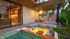 A modern outdoor living area with a pool, seating, and a hammock.