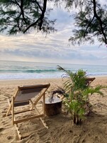 On the beach, white sand, sun loungers, beach towels