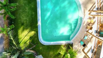 Una piscina al aire libre, tumbonas