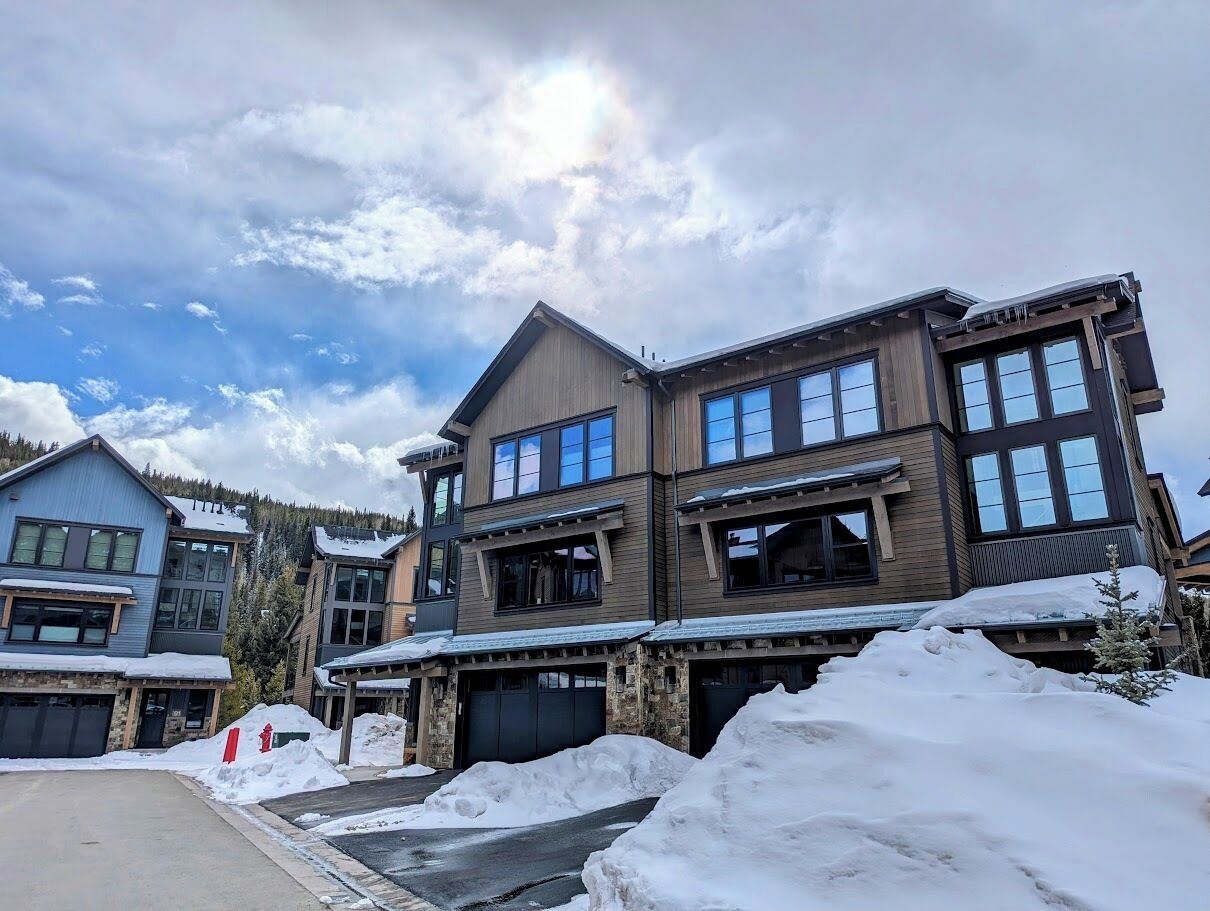A multi-story building with a modern architectural design, featuring large windows and a prominent entrance.