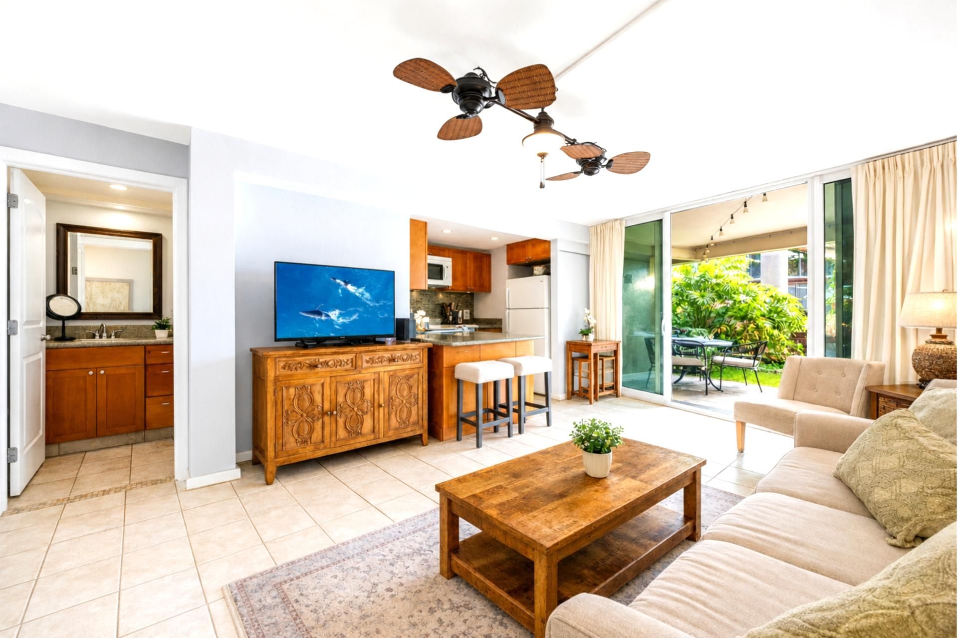 Living area and ensuite bath at Hale Ono Loa 102 -- flexible open layout with lanai access and garden views