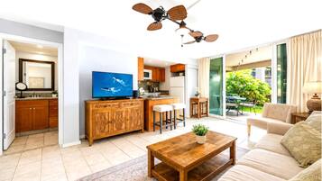 Living area and ensuite bath at Hale Ono Loa 102 -- flexible open layout with lanai access and garden views