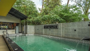 A swimming pool with a concrete wall and a sign reading "GETUPGO".