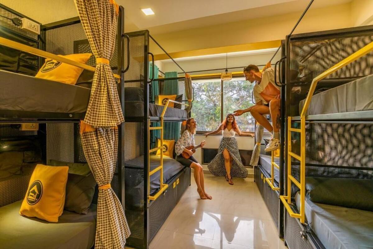 A compact, multi-level room with bunk beds and a central seating area.