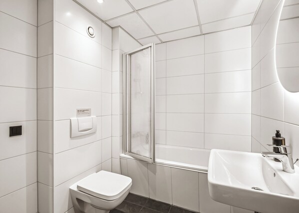 Un baño moderno con inodoro, ducha y lavabo.