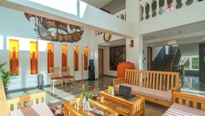 A spacious lobby with a high ceiling, a staircase, and a large window. - The Hosteller Goa, Old Goa (Panaji)